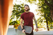 © Drobot Dean - Happy cheerful young man walking at the skate park ramp