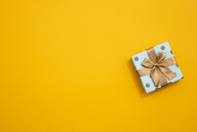 Minimalistic Wrapped Gift On Yellow Background