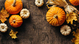 Fototapeta  - Pumpkins and corn and autumn leaves on old shabby background. Autumn background with copy space.