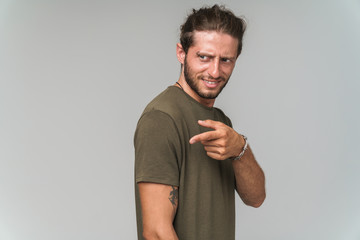 Happy young guy wearing casual clothing standing