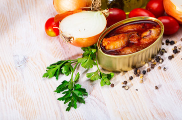 Stuffed squid in tomato sauce on background with greens, tomatoes