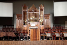 Wooden Stage, Alter, And Pipe Organ Inside An Old Church.