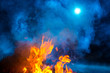© Федор Целуйко - Blue colored smoke above the night bonfire fireflame.