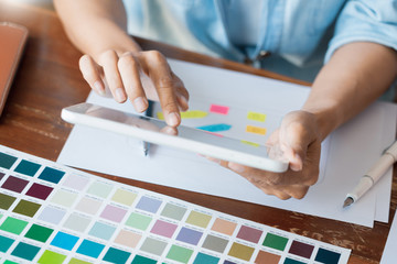 Creative UI designer teamwork meeting planning designing wireframe layout  application development mockup on smartphone screen for web mobile phone technology.