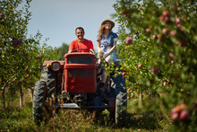 Farmers Couple Driving Tractor