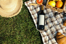 Picnic Composition With Wine And Food Against Green Grass, Space For Text