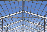 Fototapeta Konie - Steel structure of building construction on blue sky background