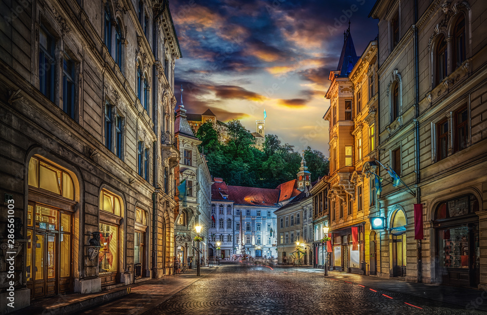 Obraz na płótnie View of the street Stritarjeva, evening city and Ljubljana's castle. Ljubljana, capital of Slovenia. w salonie