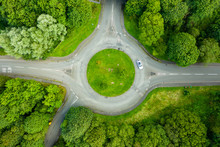 Top Down Aerial Drone View Of A Small Traffic Roundabout On A Quiet Road