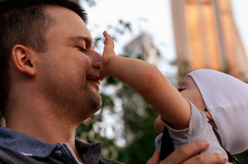 Father and one year old son against the sky and skyscrapers. Travel with children, the development of emotional intelligence. Early development.