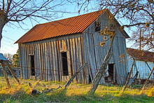 Rustic Barn In Farm Field