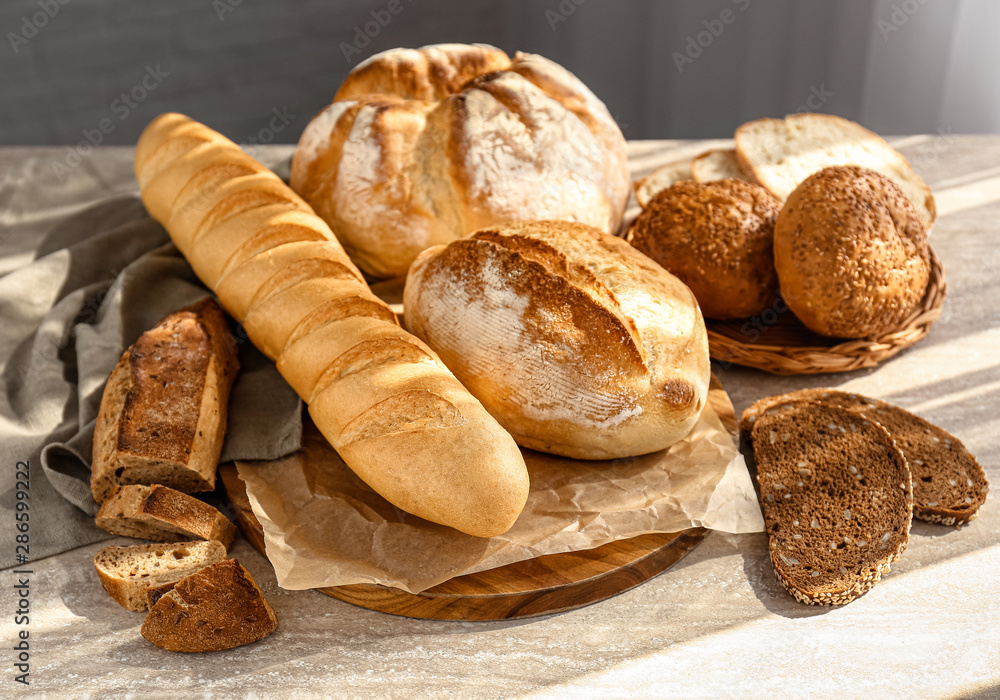 Assortment of fresh bread on table - obrazy, fototapety, plakaty 