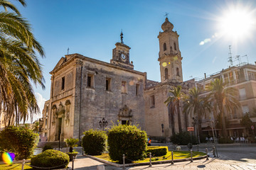 The mother church of Cavallino, Lecce, Puglia, Salento, Italy. In baroque style. Wooden portal and niches with statues on the sides, on the facade.