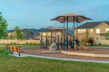 Wall Mural - Park with playground and benches in front of multi storey family homes