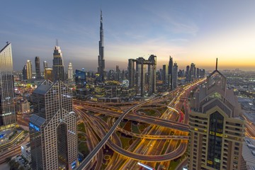 Canvas Print - Aerial shot of the buildings and the streets of Dubai with a beautiful sky in the background