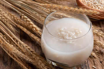 Canvas Print - Barley water in glass with raw and cooked