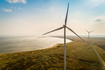  Aerial view of wind turbines on a sea shore.