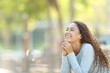 © Antonioguillem - Happy mixed-race woman meditating in a park