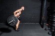 © Srdjan - Young muscular sweaty crossfit man with big muscles doing barbell weight training workout in the gym dark image