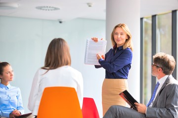 Wall Mural - Mature businesswoman planning strategy with colleagues during meeting at new office