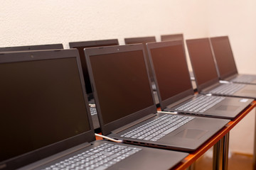 many laptops are on the table. computer exhibition demonstration. it technology