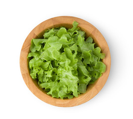 lettuce leaf in wood bowl isolated on white background. top view