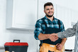 © LIGHTFIELD STUDIOS - cropped view of woman shaking hands with happy bearded handyman