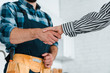 © LIGHTFIELD STUDIOS - cropped view of woman shaking hands with handyman