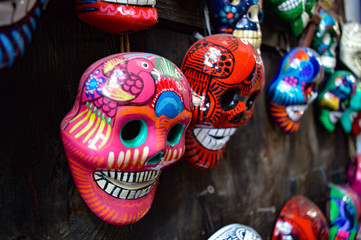 Many hand-painted, brightly-colored Dia de los Muertos skull souvenirs