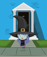 little girl with witch costume in the house door