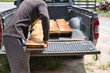 © phoderstock - Carpenter uploading pile of lumber woods and palnks on to pick up truck. Woodworking concept.