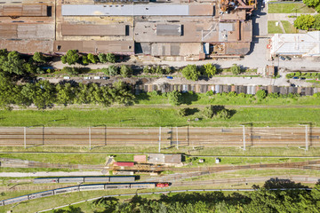 Wall Mural - aerial view of city industrial district. trains on railroad transferring goods. drone image