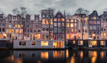 Traditional Dutch Buildings And Houseboats Along The Canals Of Amsterdam, Netherlands