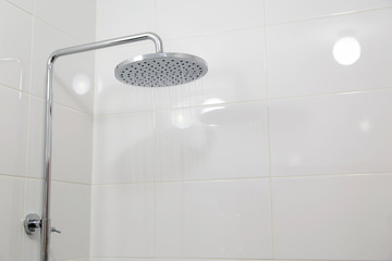  Chrome shower on white tile.Horizontally, Vertically.