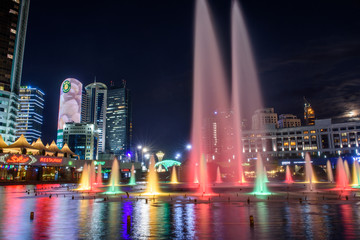 Wall Mural - Nur-Sultan, Kazakhstan, August 2019, Fountains with lighting on the background of tall buildings in the center of the capital of Kazakhstan.