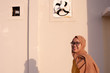 © SVRSLYIMAGES - Portrait of a muslim woman wearing head scarf and fashionable clothes standing against a wall