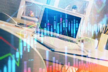 Financial market graph hologram and personal computer on background. Double exposure. Concept of forex.