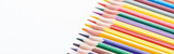 Fototapeta Tęcza - Panoramic shot of color pencils row isolated on white