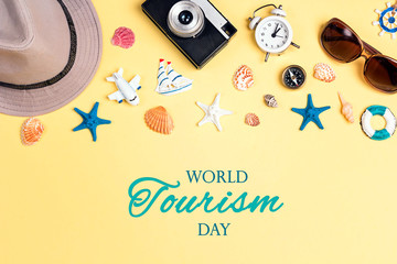 World tourism day background. Flat lay travel concept with vacation accessories.