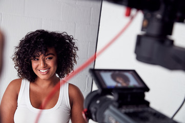 Wall Mural - Female Model Posing For Video Camera On Film Set