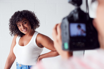 Wall Mural - Model Posing For Female Photographer In Studio Portrait Session