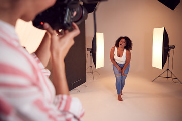 Wall Mural - Model Posing For Female Photographer In Studio Portrait Session