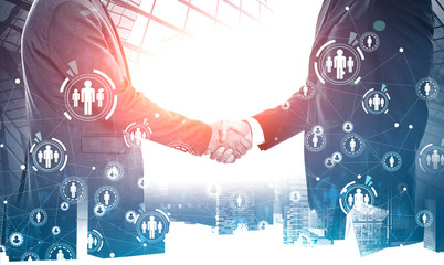 Wall Mural - Businessmen shaking hands in city, social network