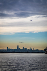 Wall Mural - Plane flying over San Francisco skyline close to sunset