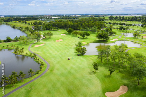 Fotomural Aerial view of pound on golf course with player, footpath on golf course, playr enjoying the game under sun, golf field