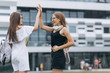 © uflypro - Two students posing looking at you outdoors in an university campus. Portrait of students smiling