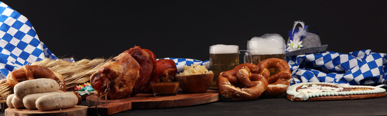 Traditional German cuisine, Schweinshaxe roasted ham hock. Beer, pretzels and various Bavarian specialties. Oktoberfest background