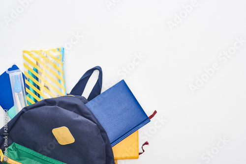 Fotografía Blue schoolbag with notepads, pencil case and school supplies isolated on white