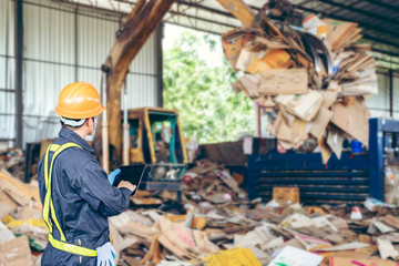 Engineer Standing to work with tablet Machines in the recycling industry