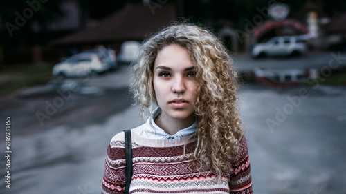 Cute Girl Blonde With Curly Hair Brown Eyes Wearing A Sweater
